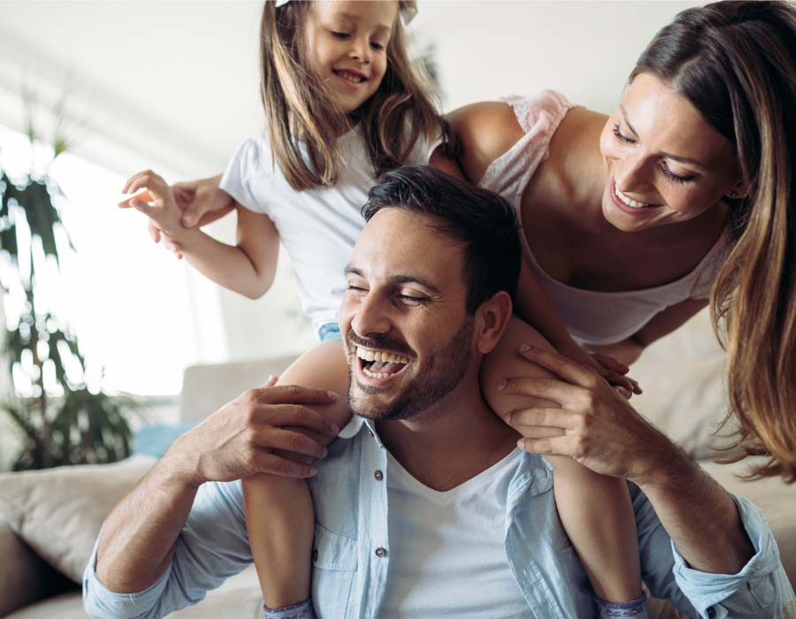 Family smiling in the living room.